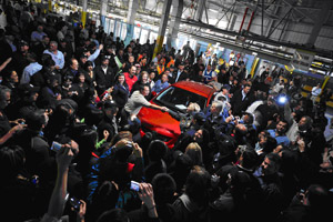 NUMMI team members sending the final Corolla off the production line