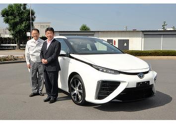 Akio Toyoda, Toyota president (left) and Toshimitsu Motegi, Japanese Minister of Economy, Trade and Industry (right) pictured with Toyota's fuel cell sedan