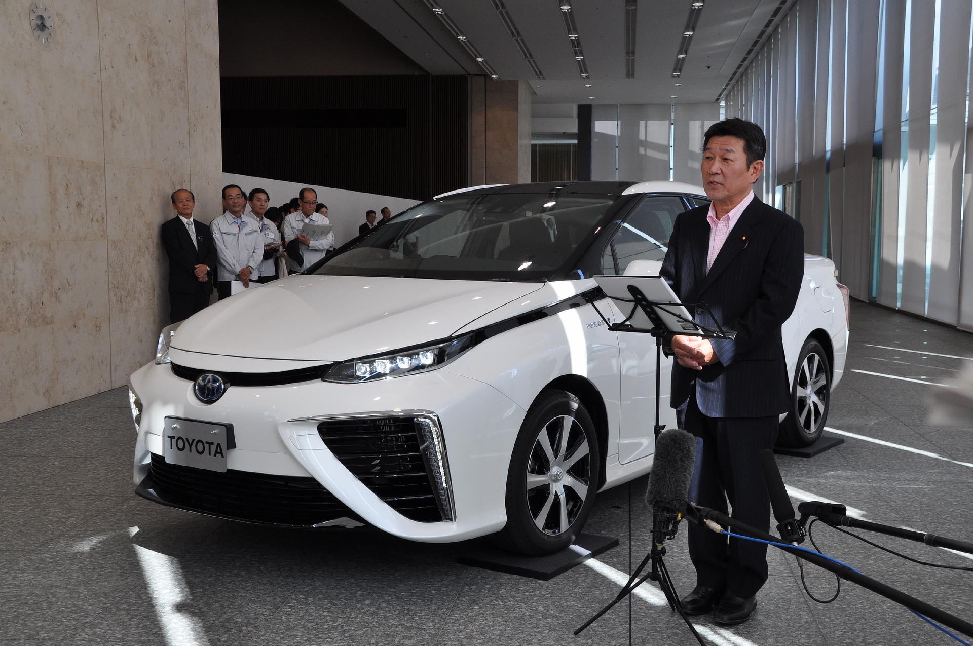 Toshimitsu Motegi, Japanese Minister of Economy, Trade and Industry pictured with Toyota's fuel cell sedan