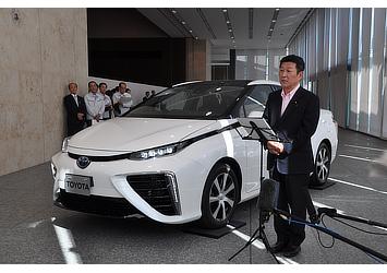 Toshimitsu Motegi, Japanese Minister of Economy, Trade and Industry pictured with Toyota's fuel cell sedan