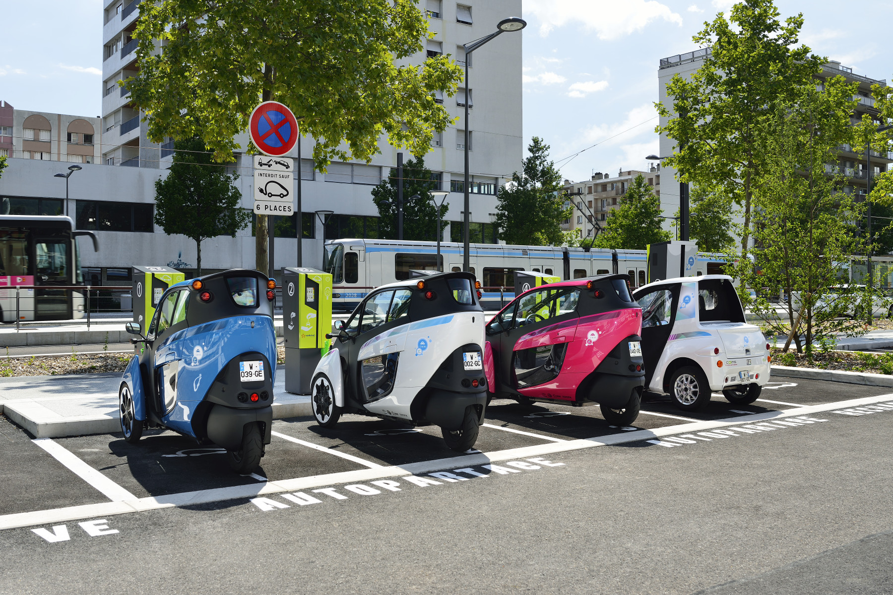 Toyota i-ROAD and COMS at a charging station for 