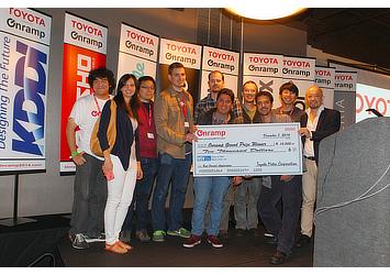Eye in the Sky receiving the $10,000 prize from Managing Officer Riki Inuzuka