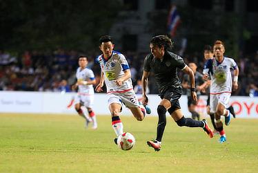 Buriram United's Coutinho trips the ball away from Lanexang United's Phoutthaxay