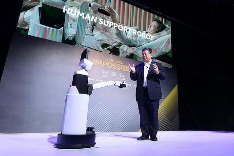 Susumu Matsuda, President, Toyota Motor Asia Pacific, interacting with the Toyota Human Support Robot at the Asia launch of Start Your Impossible