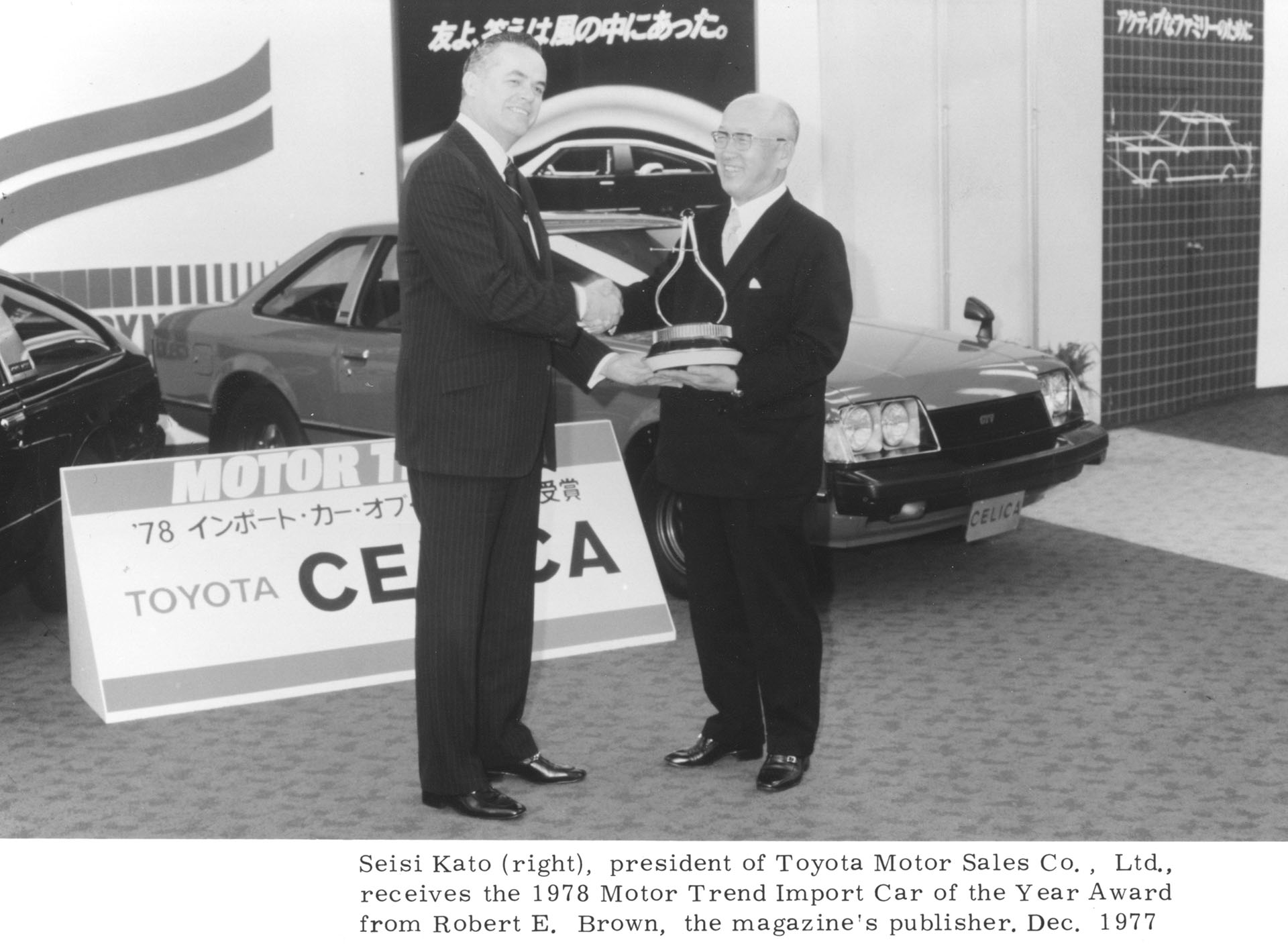 Seisi kato (right), president of Toyota Motor Sales Co., Ltd., receives the 1978 Motor Trend Import Car of the Year Award from Robert E. Brown, the magazine's publisher.