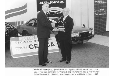 Seisi kato (right), president of Toyota Motor Sales Co., Ltd., receives the 1978 Motor Trend Import Car of the Year Award from Robert E. Brown, the magazine's publisher.